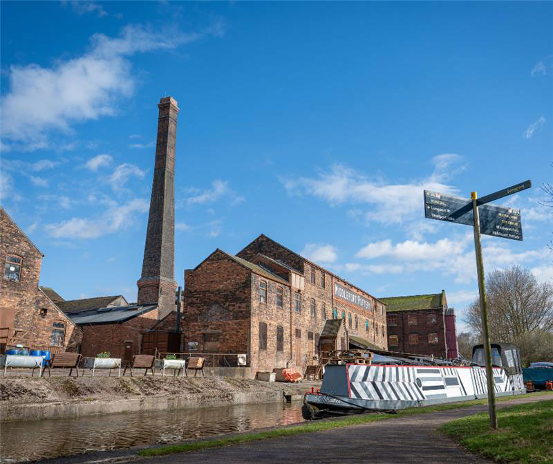 Canalside view of a canal barge next to Middleport pottery
